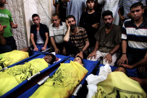 Palestinians mourn over the body of boys from the Baker family, whom medics said was killed with three other children from the same family by a shell fired by an Israeli naval gunboat